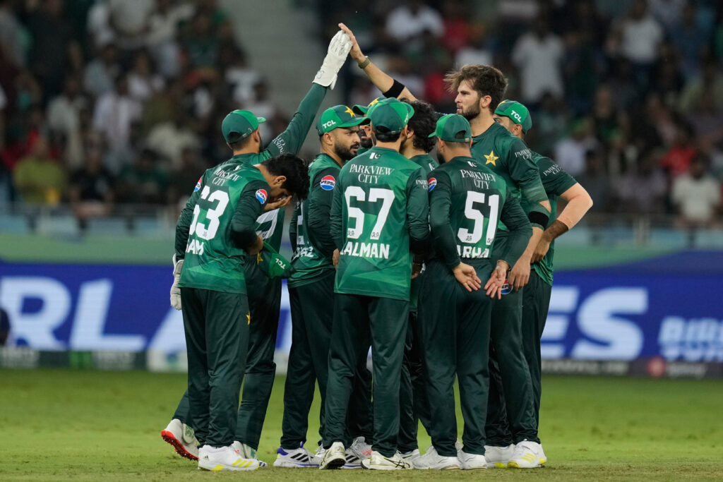 Pakistan cricket team celebrating during a match on the field.