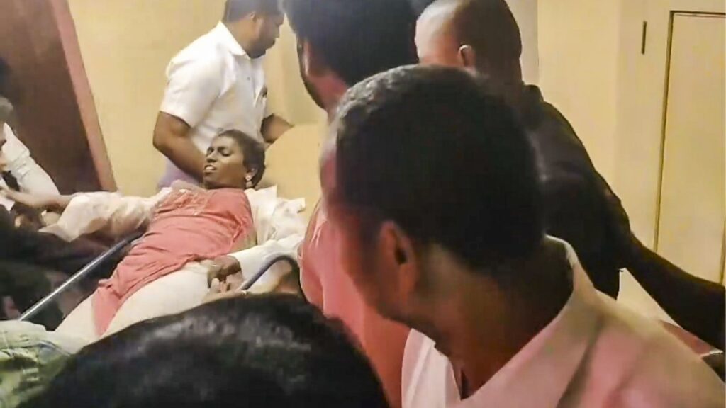 A woman being brought to a hospital after a stampede-like situation was witnessed during a rally presided by Tamilaga Vettri Kazhagam chief and actor Vijay, in Karur district in Tamil Nadu on Saturday. Many persons, including a few children, fainted at the gathering, according to officials. (PTI Photo)